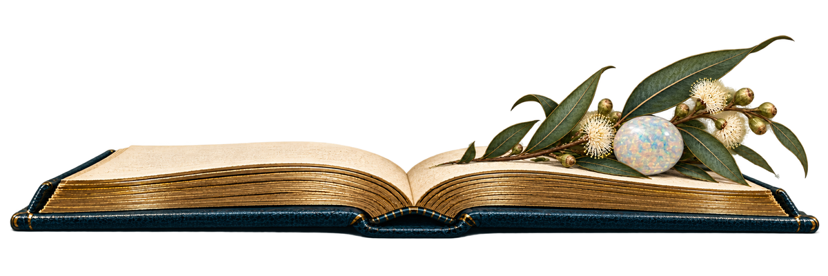 An open book with eucalyptus foliage and an opal